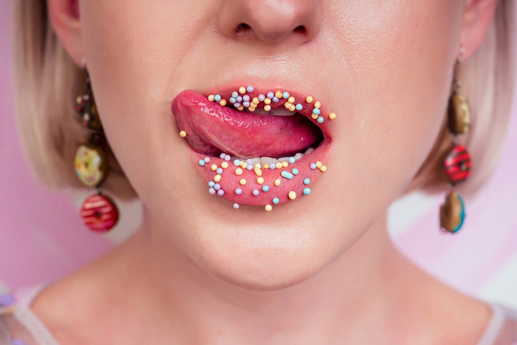 portrait-beautiful-blonde-barbie-woman-perfect-makeup-tongue-sexy-licking-lip-donuts-earrings